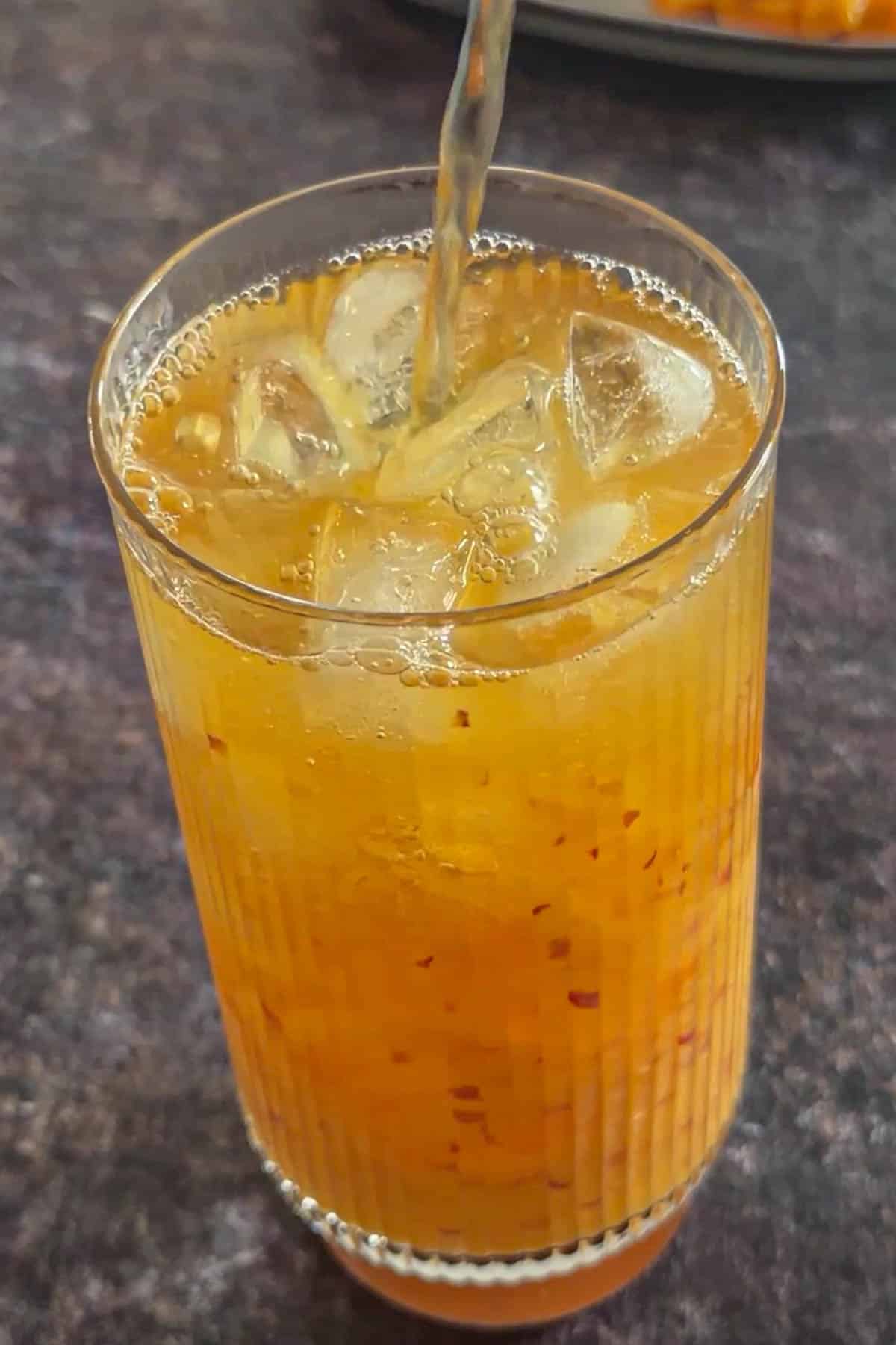 Cooled tea poured over ice and peach mango puree.