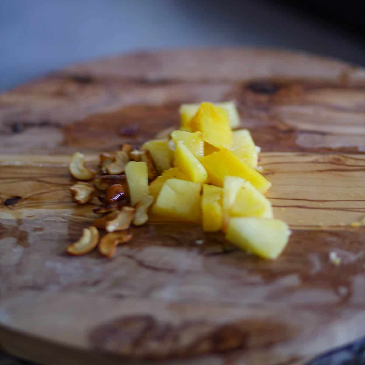 Chop pineapple, raisins, and cashews and add int he curry.