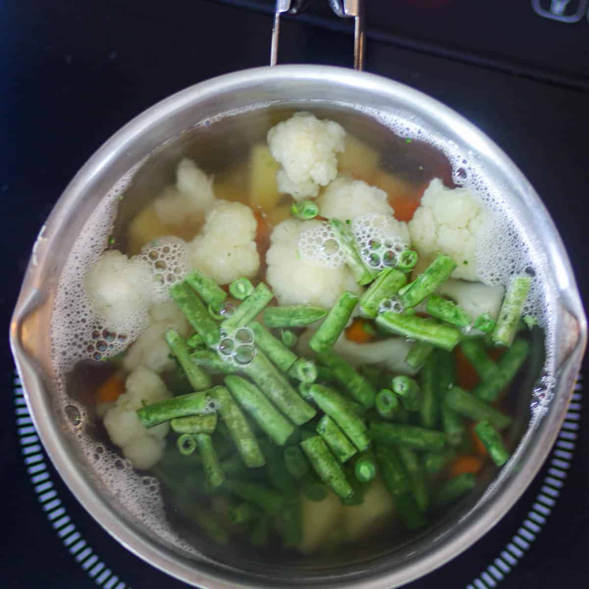 Add veggies in water and boil them.