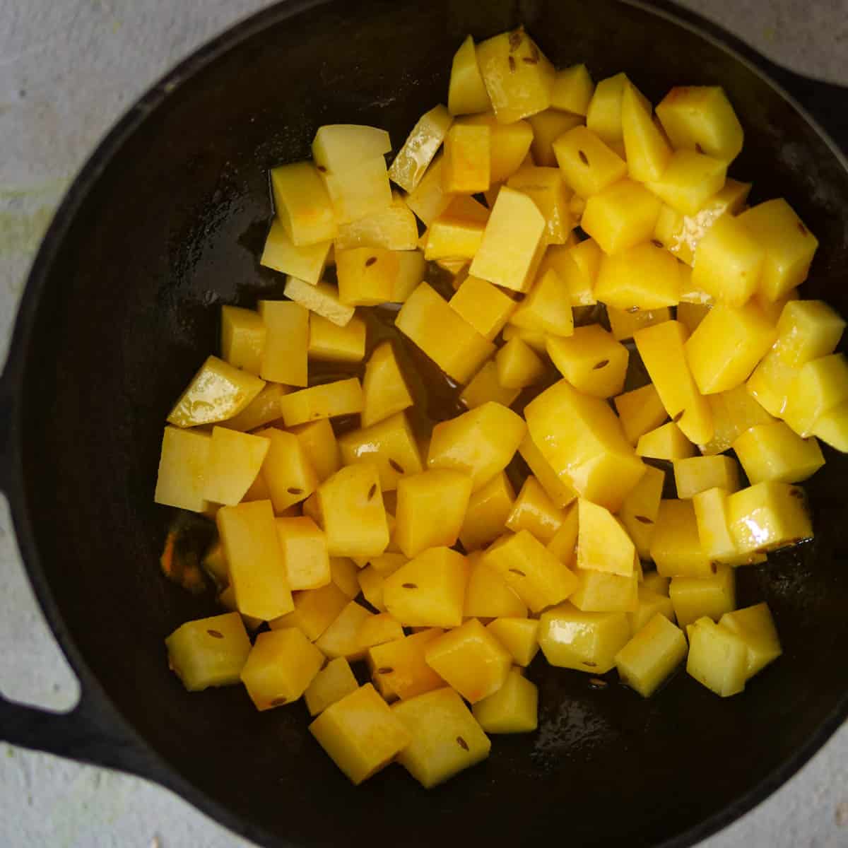 Add potatoes and cook at low heat.