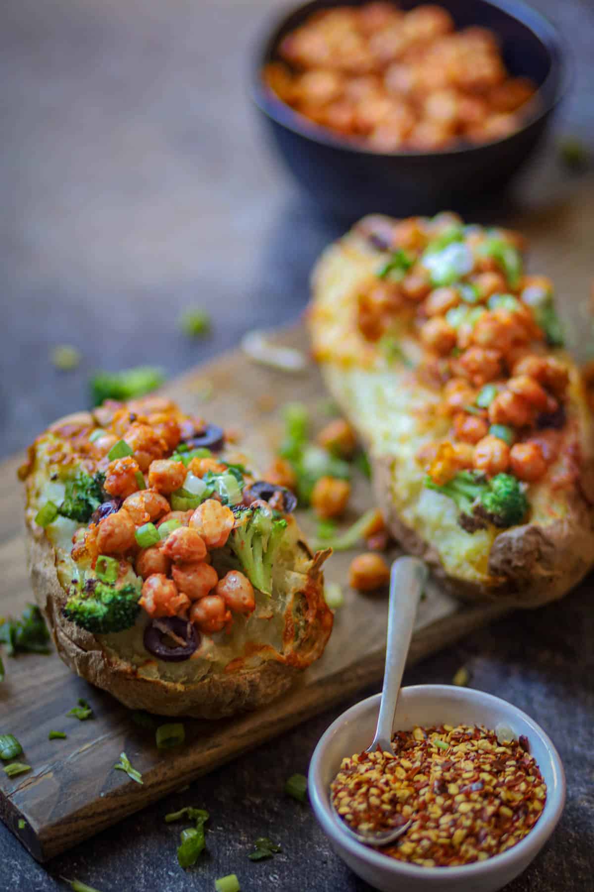 Ninja Foodi baked Pottaoes served on a wood plank.