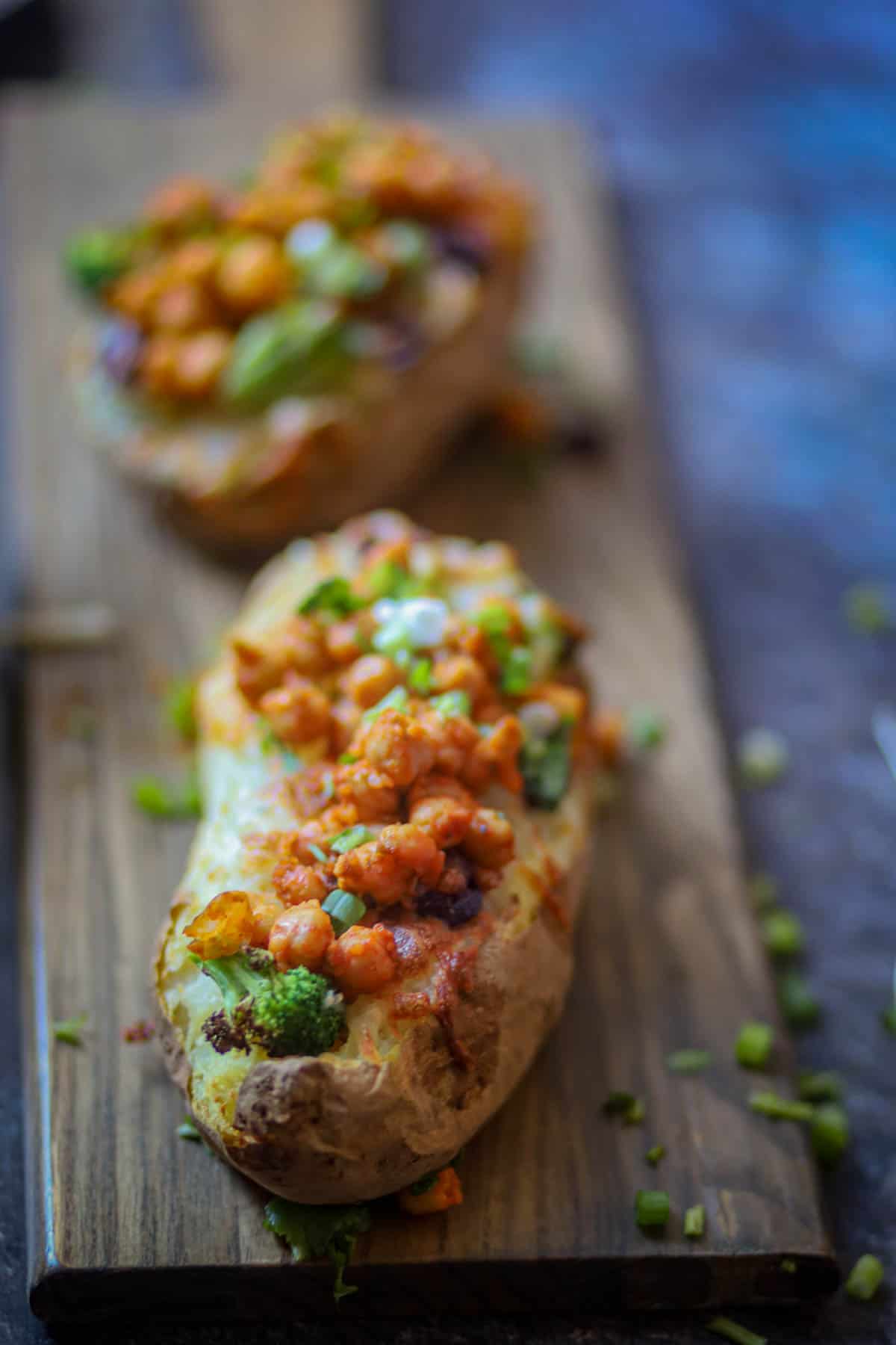 Baked Pottaoes garnished with green onion and red chili flakes.