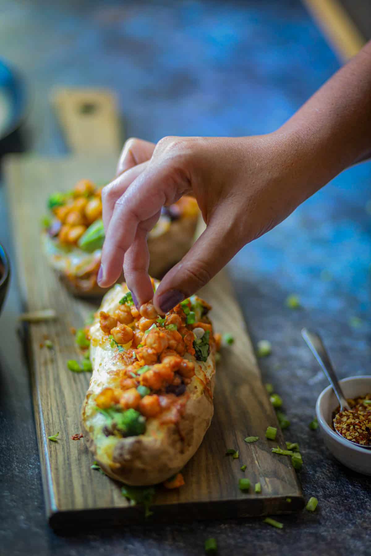 Ninja Foodi Baked Potatoes topped with chickpeas.