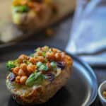 Ninja Foodi Baked Pottaoes serve don a black plate.