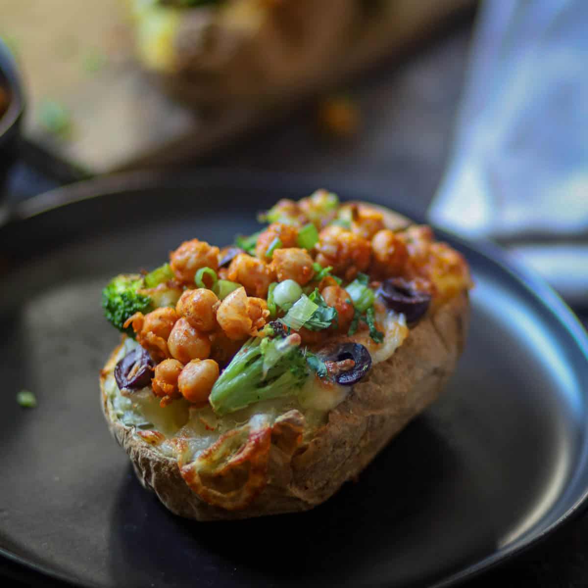 Baked Potatoes served on a black palte.