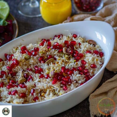Close image of rice with pomegranate seeds in a big white bowl.
