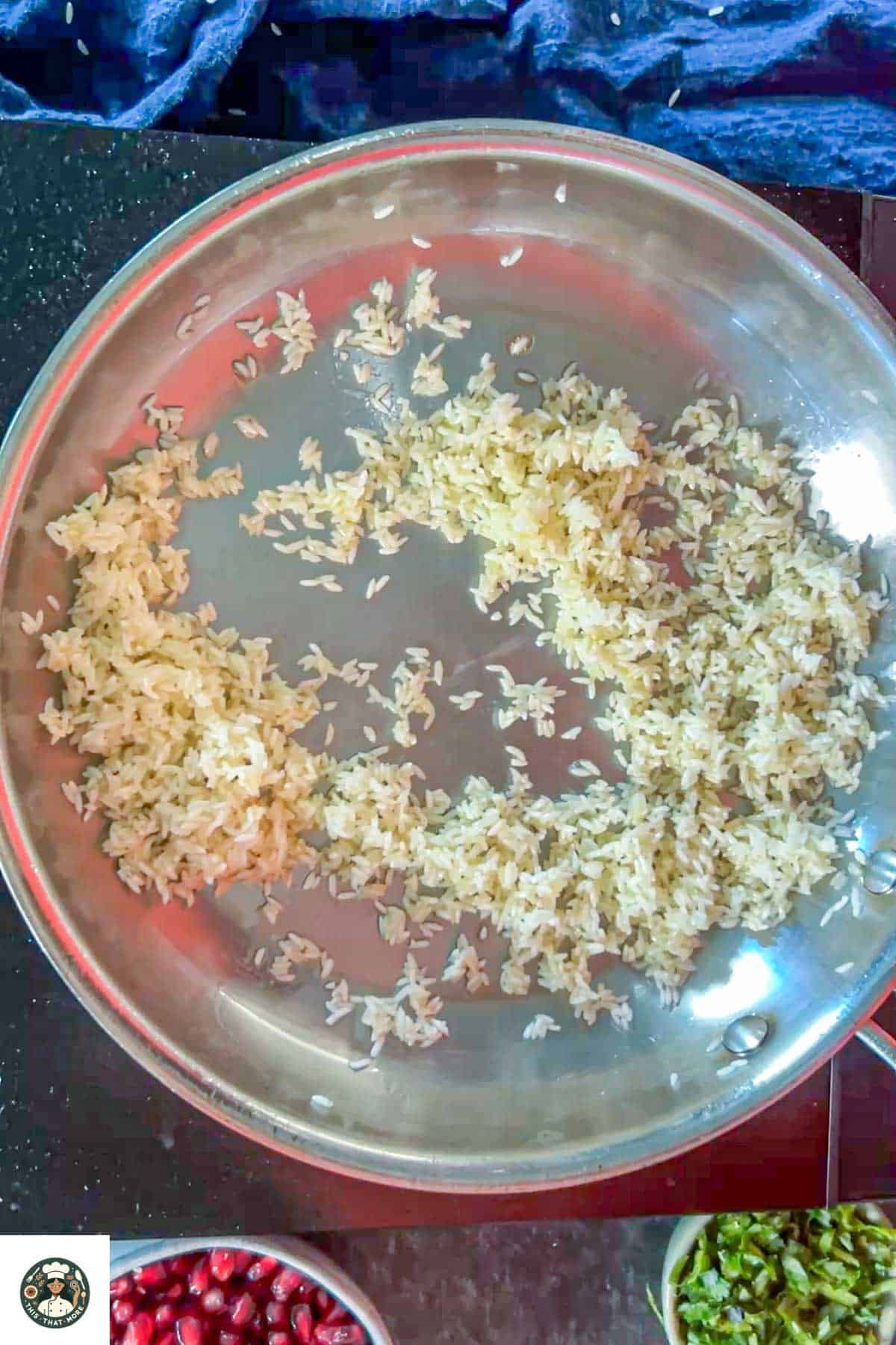 Image of rice and ghee in a steel skillet.