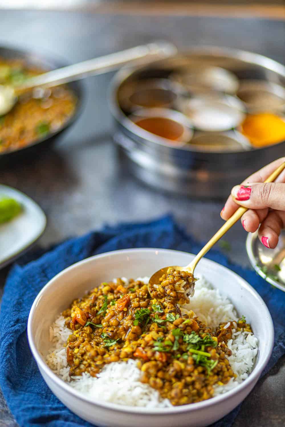 A side shot of a spoonful of green moong dal recipe.