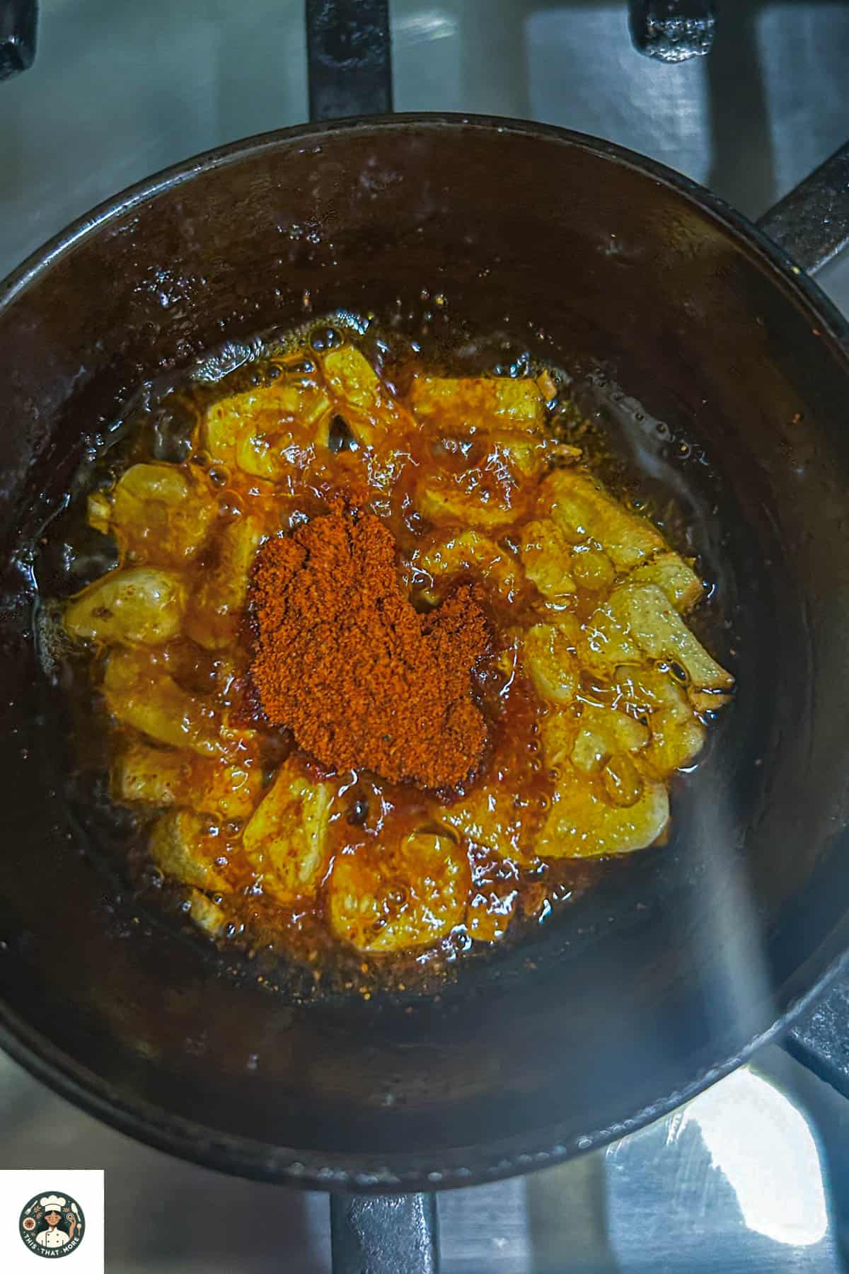 Overhead shot of adding spices to the tempering.