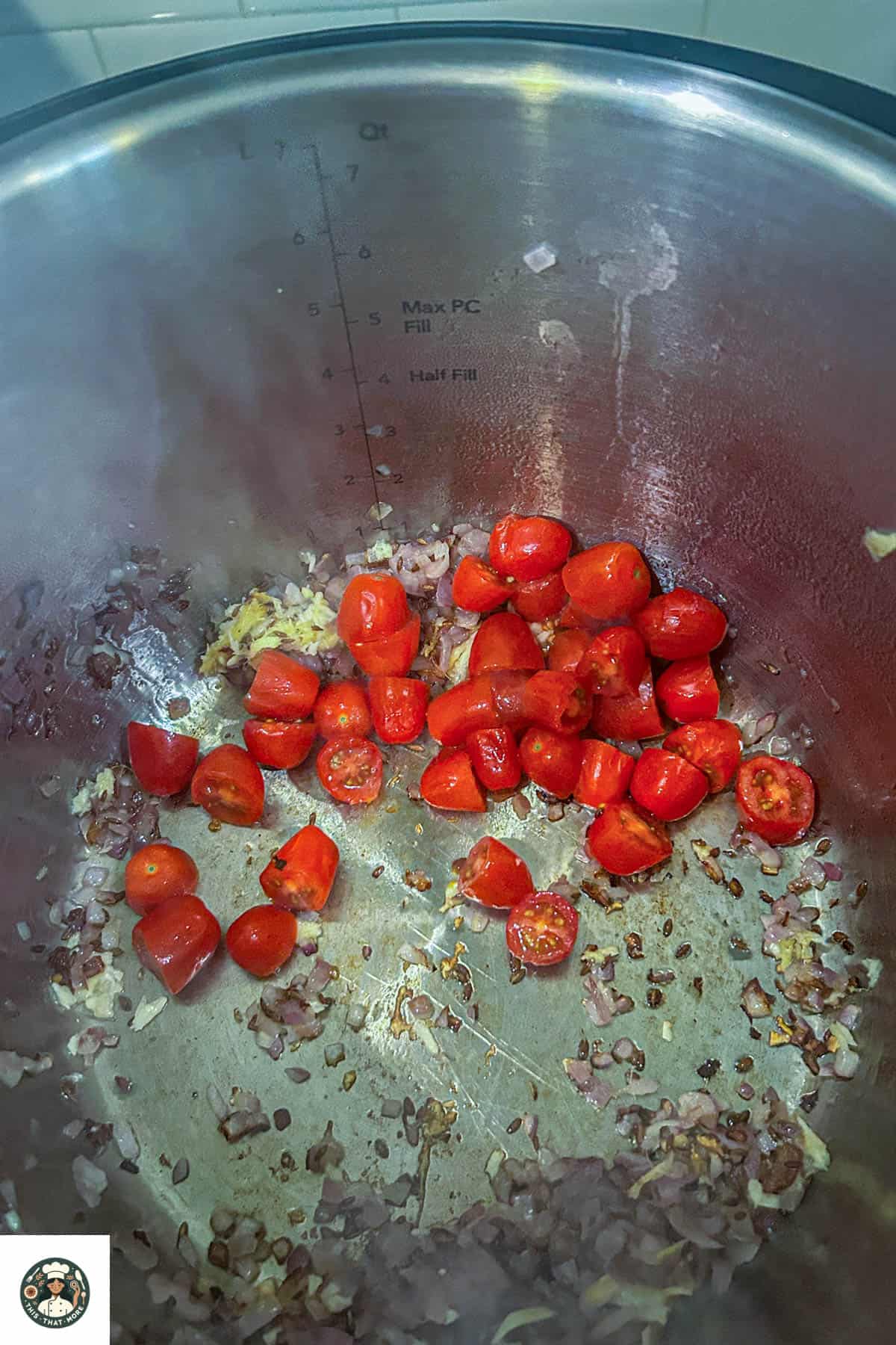 Overhead shot of tomatoes getting cooked to make masala.