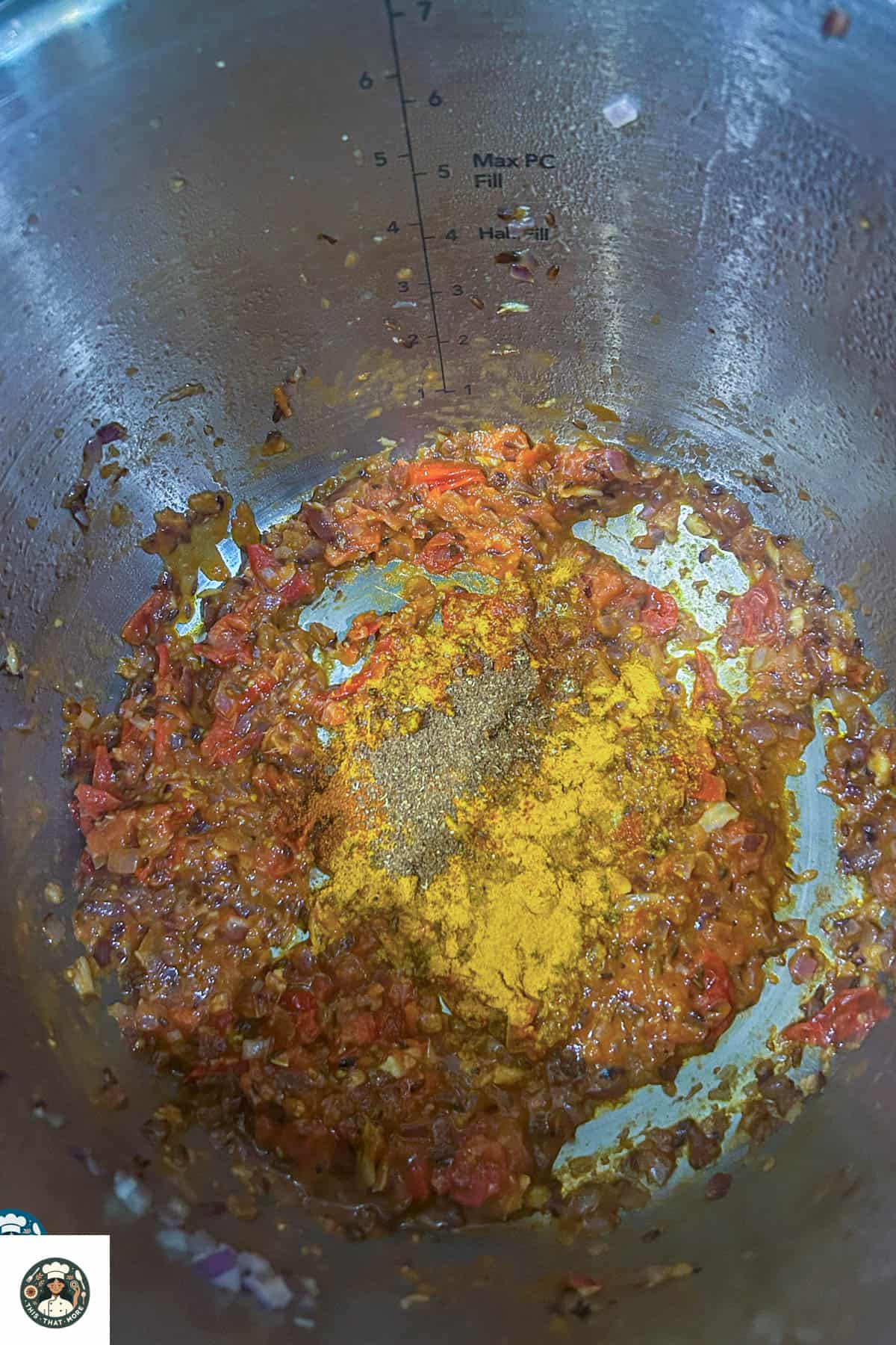 Overhead shot to add spices to the masala.