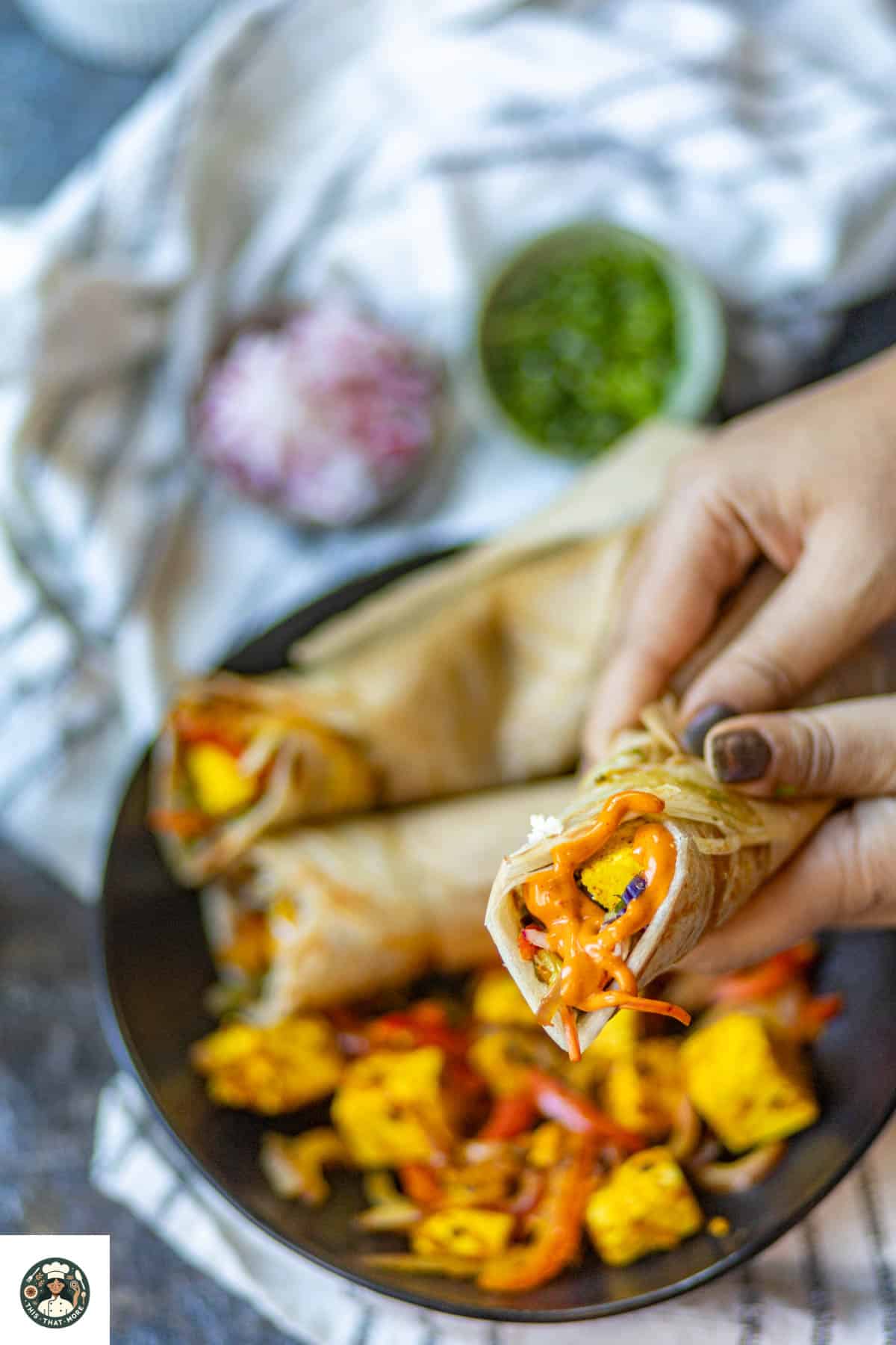 Shot of a kathi roll covered in hot sauce.