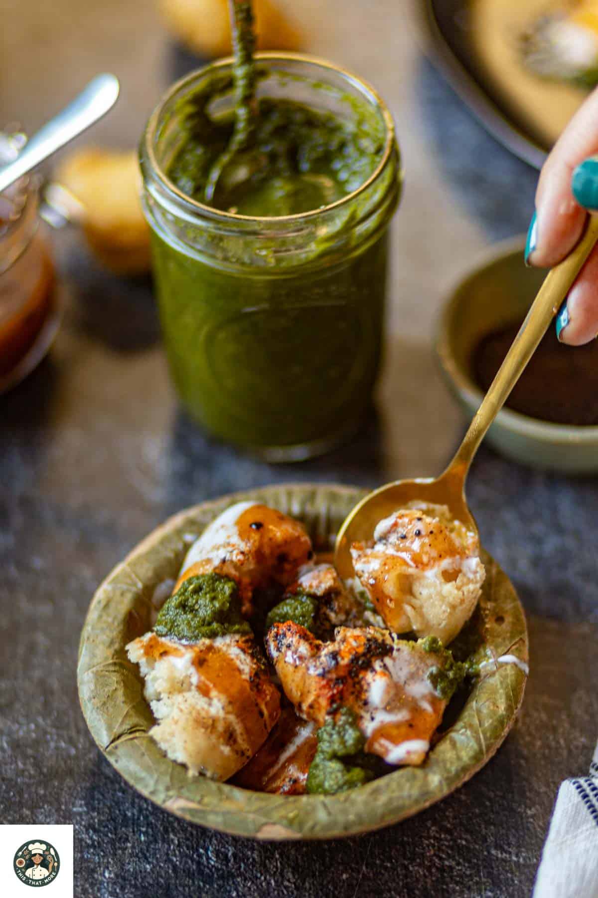 Image of Dahi Bhall Chaat served in a green leaf bowl.
