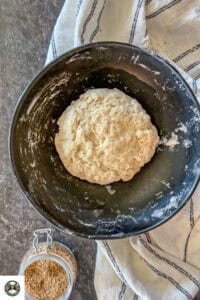Image showing the kneaded dough in a black bowl.
