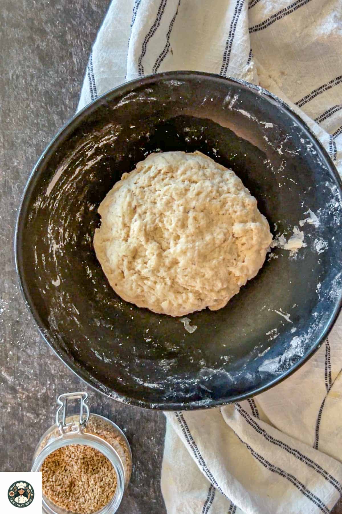 Image showing the kneaded dough in a black bowl.