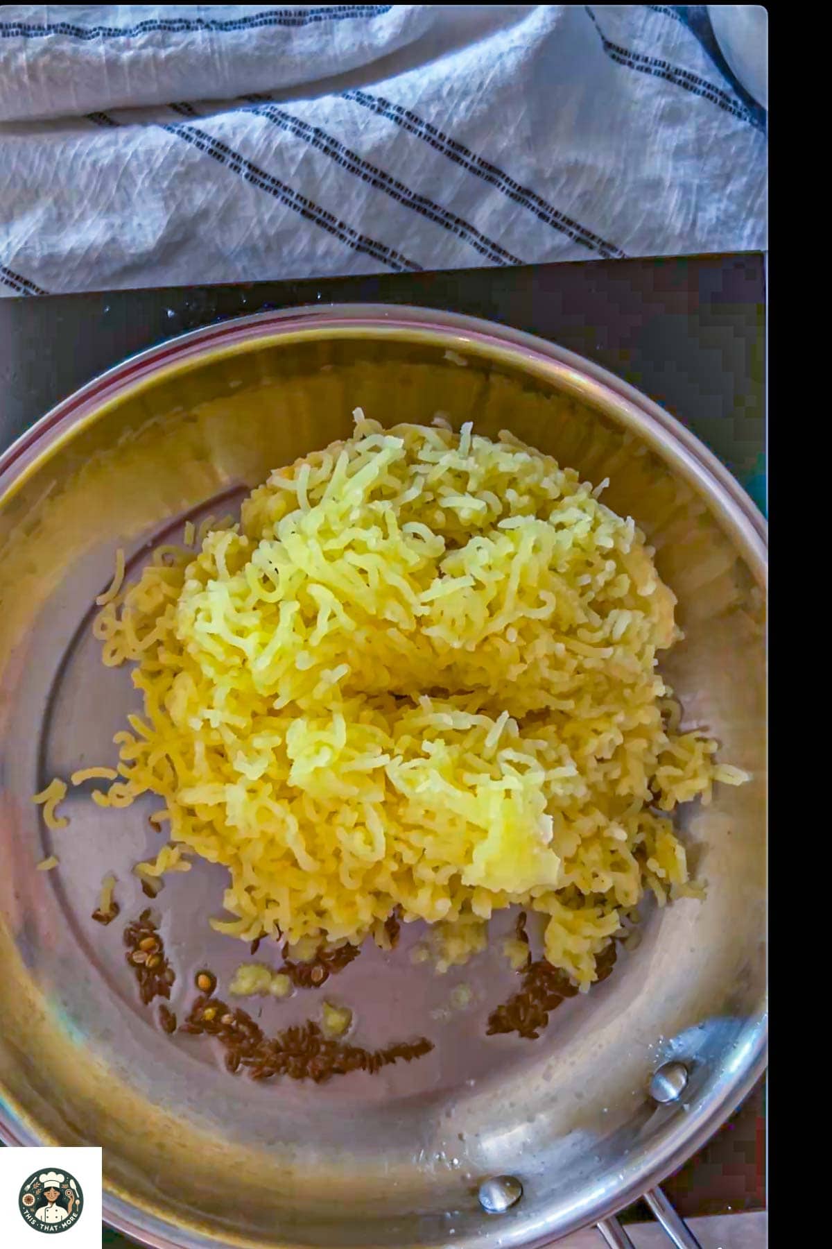 Add grated potatoes in the pan with cumin seeds and corriander seeds.