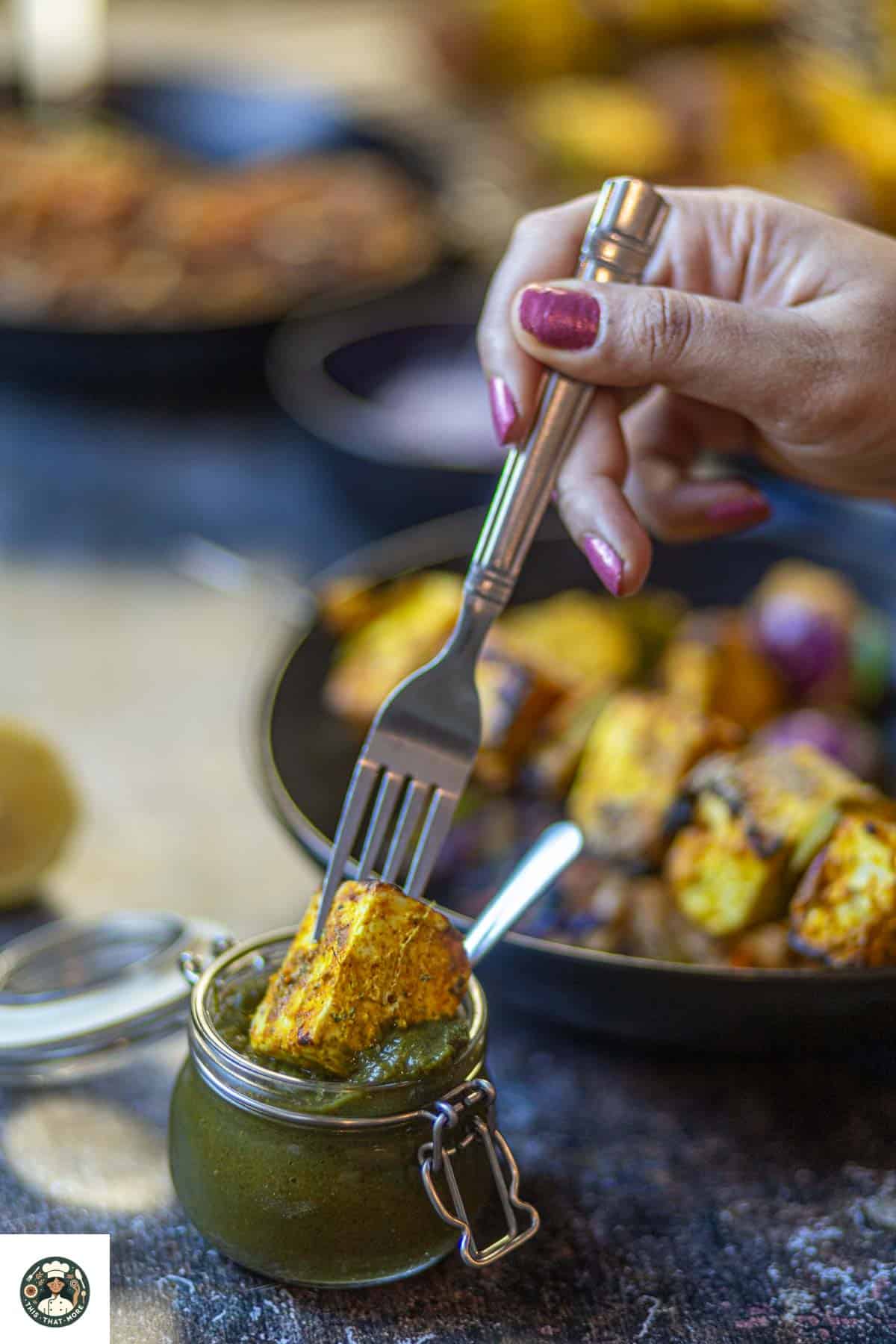 Image showing tandoori paneer tikka dipped in green chutney.