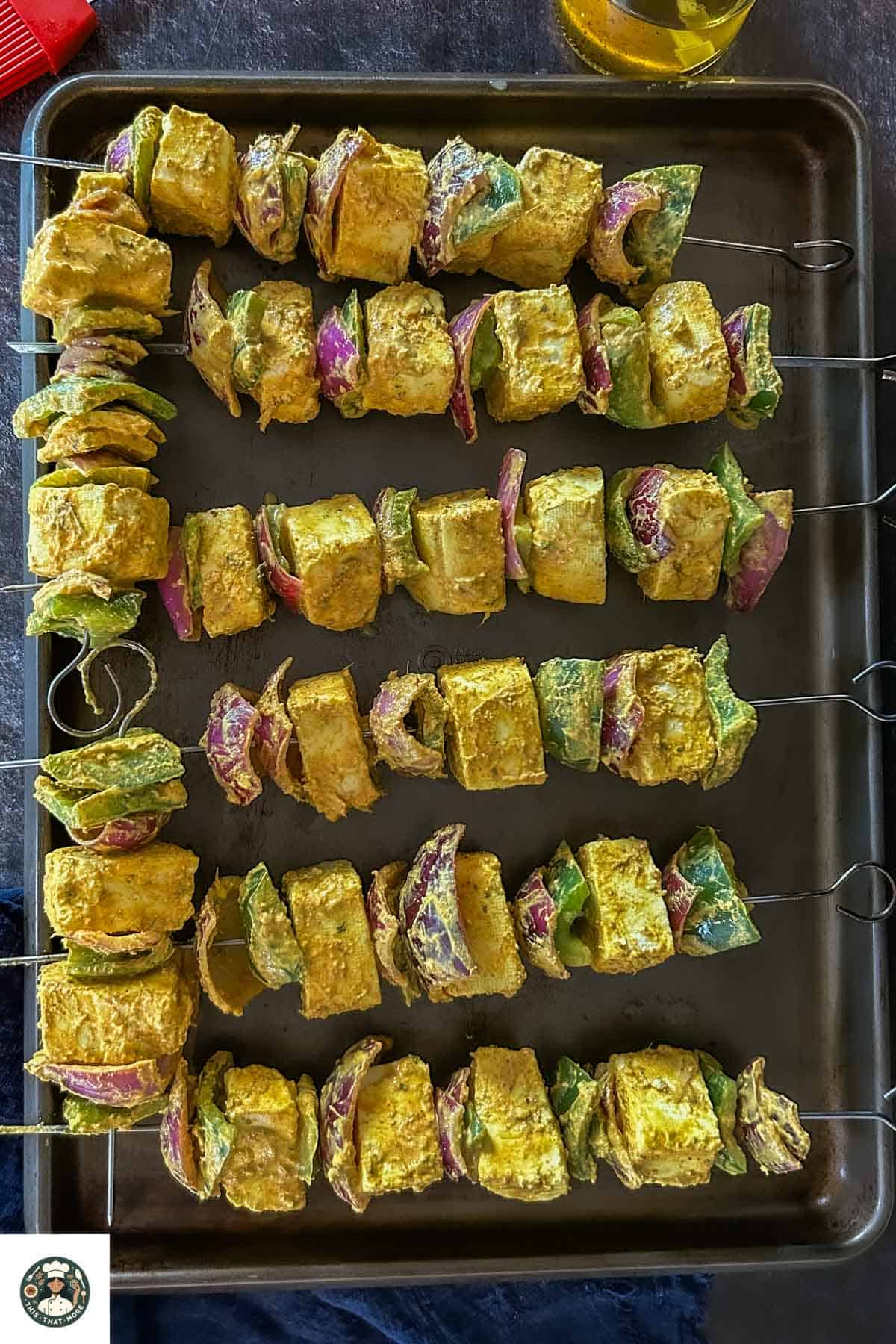 Image showing all skewers placed on a baking tray for grilling/roasting.