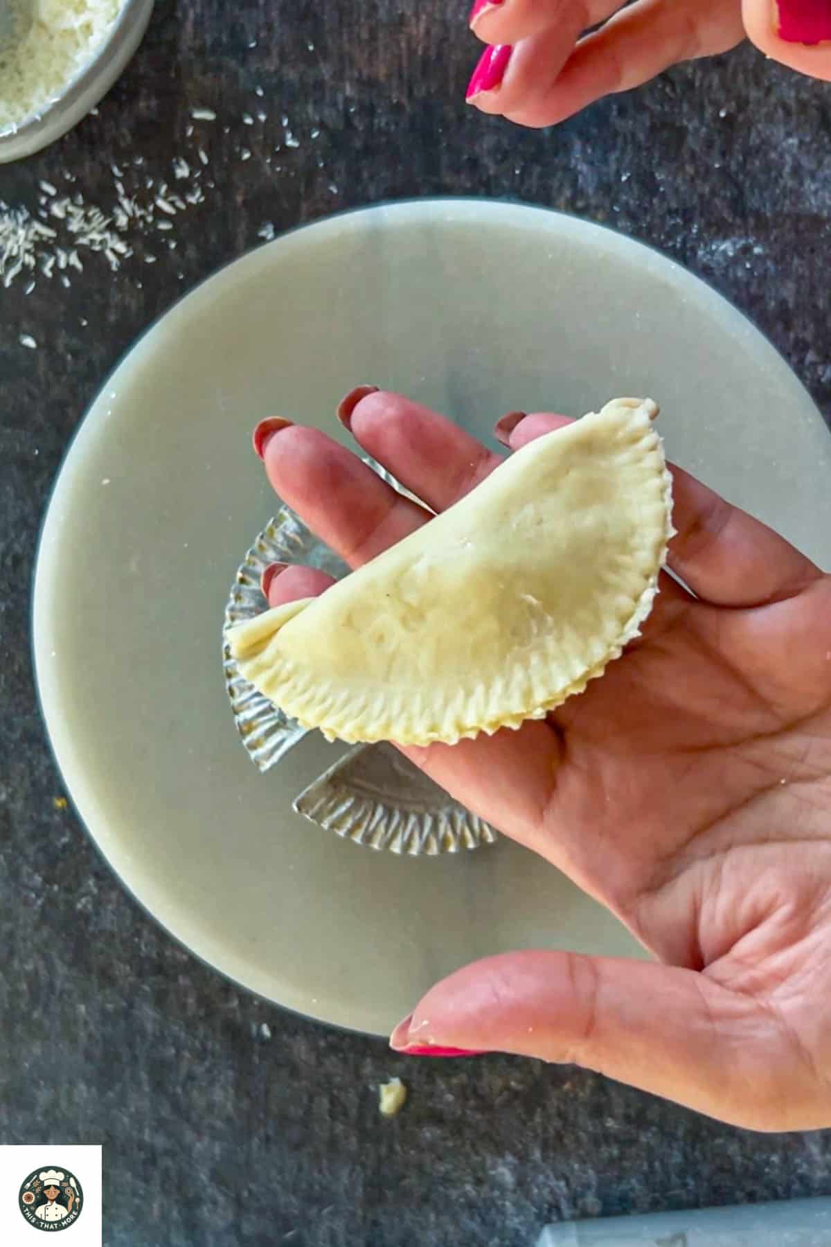 Shaping the gujiya using a gujiya mold.