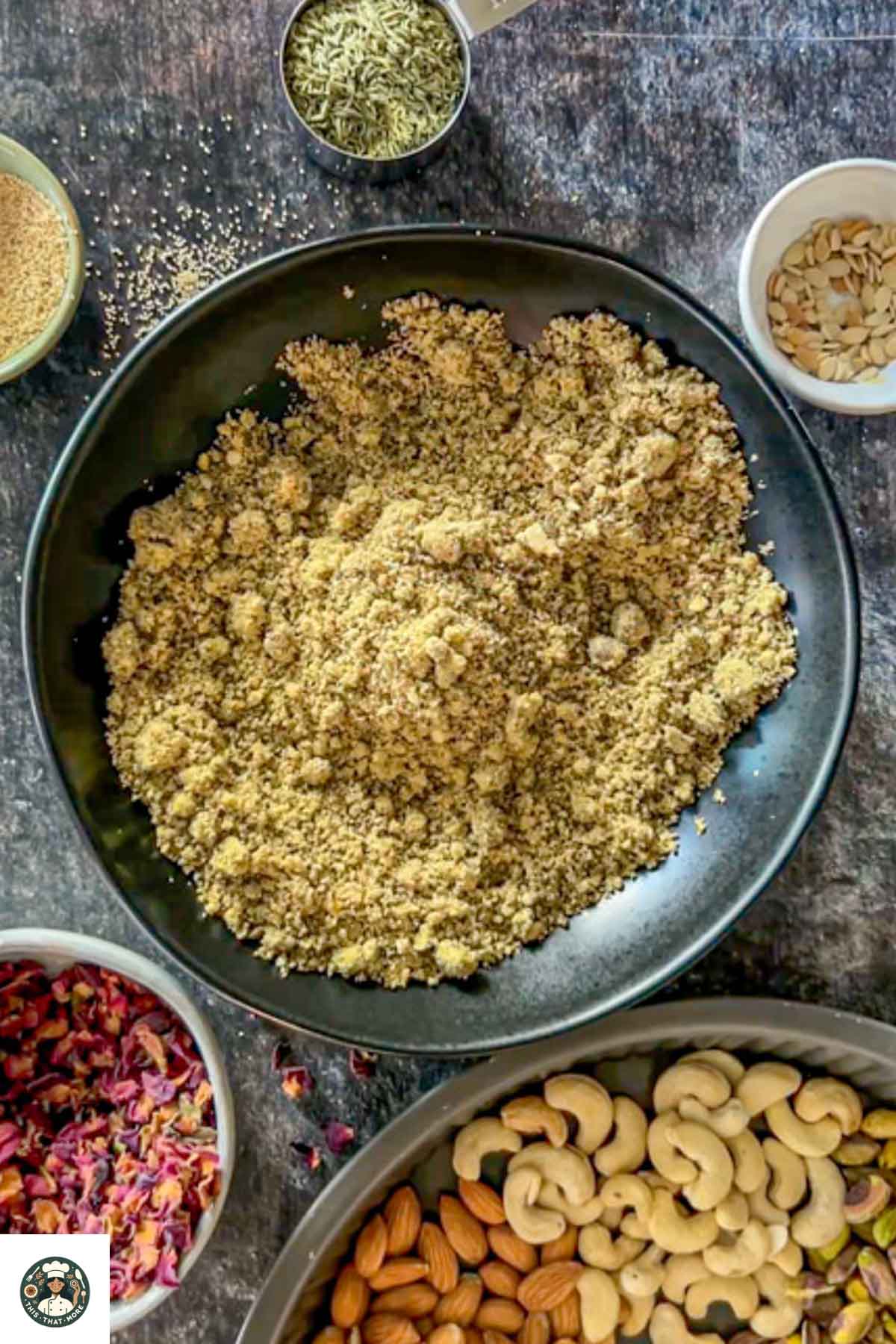 Nut powder and spice powder combined properly in the black bowl to make the thandai powder.