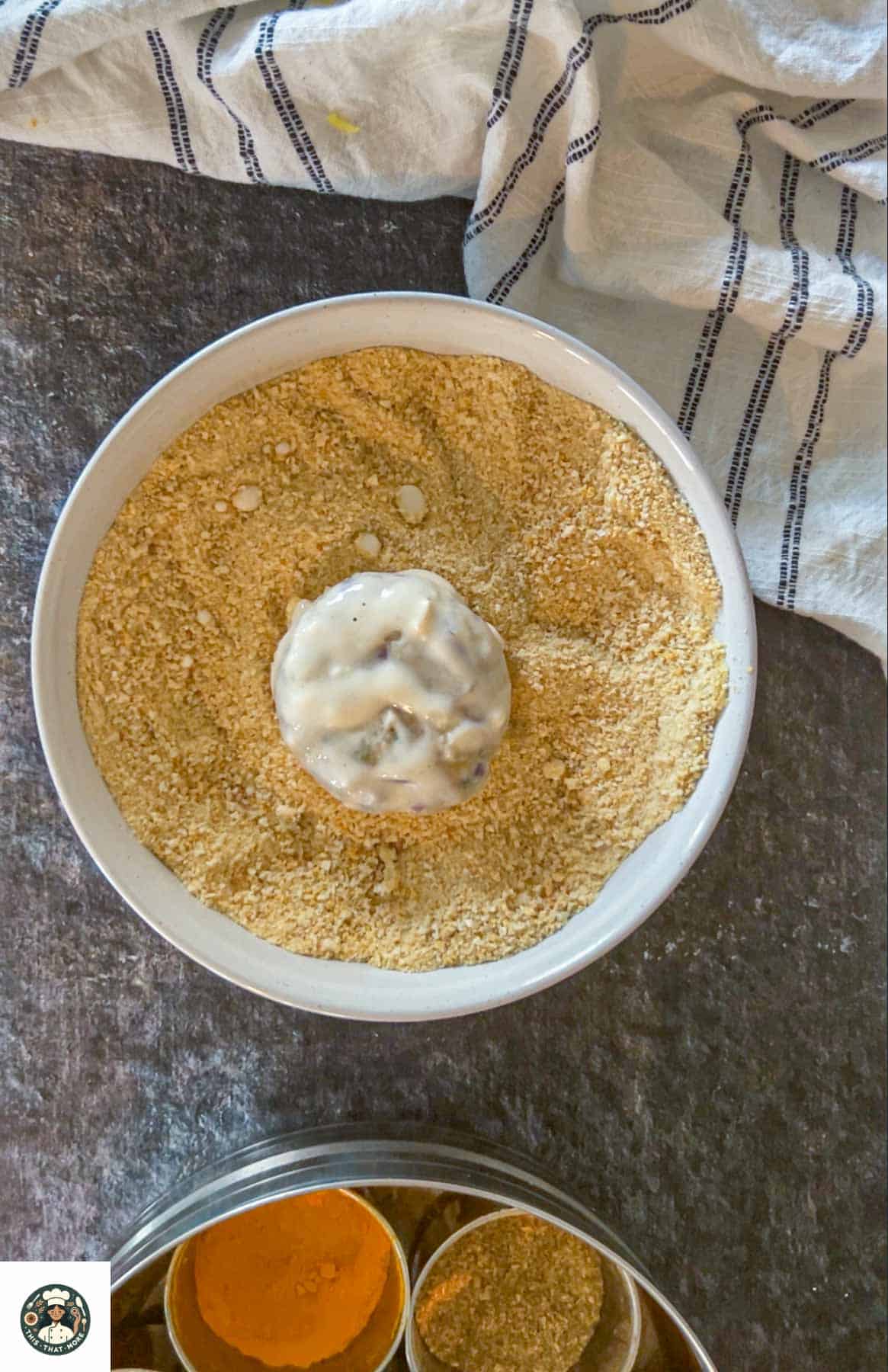 Take a ball-shaped potato mixture and flatten it. Then dip it in all-purpose flour batter.