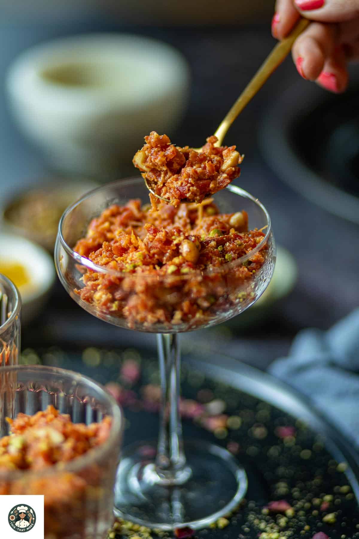 Image of spoonful of carrot halwa with khoya.