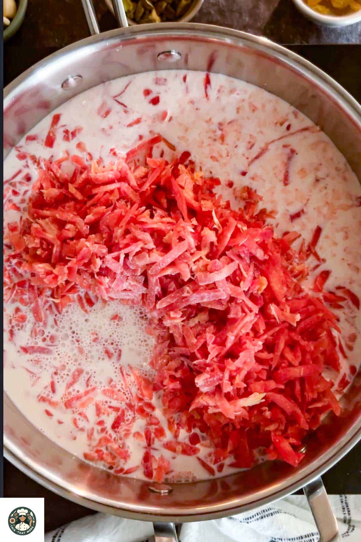 Add grated carrot and milk in a pan and let it come to boil.