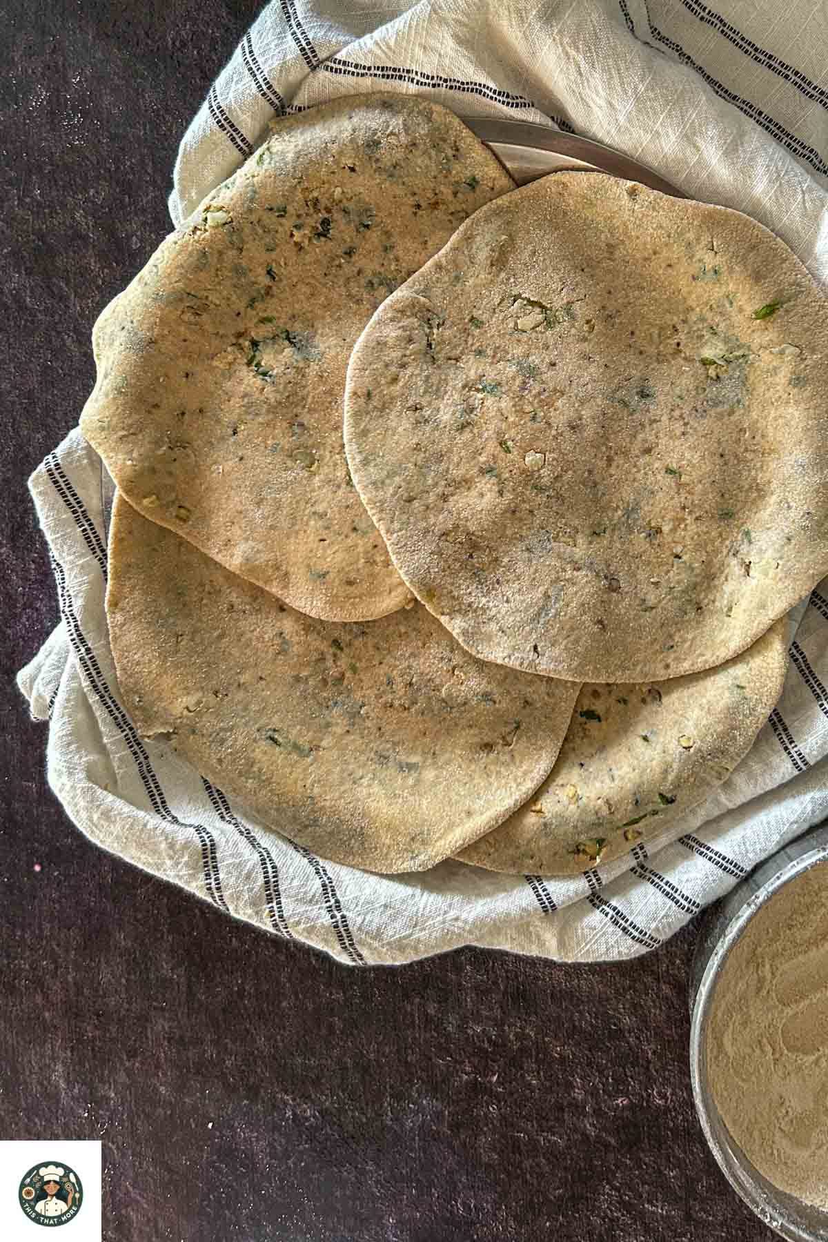 Rolled parathas placed on a plate.