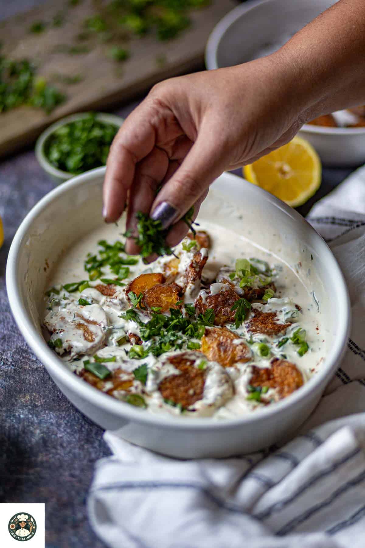 Image showing salad made with smashed potatoes garnished with parsley.