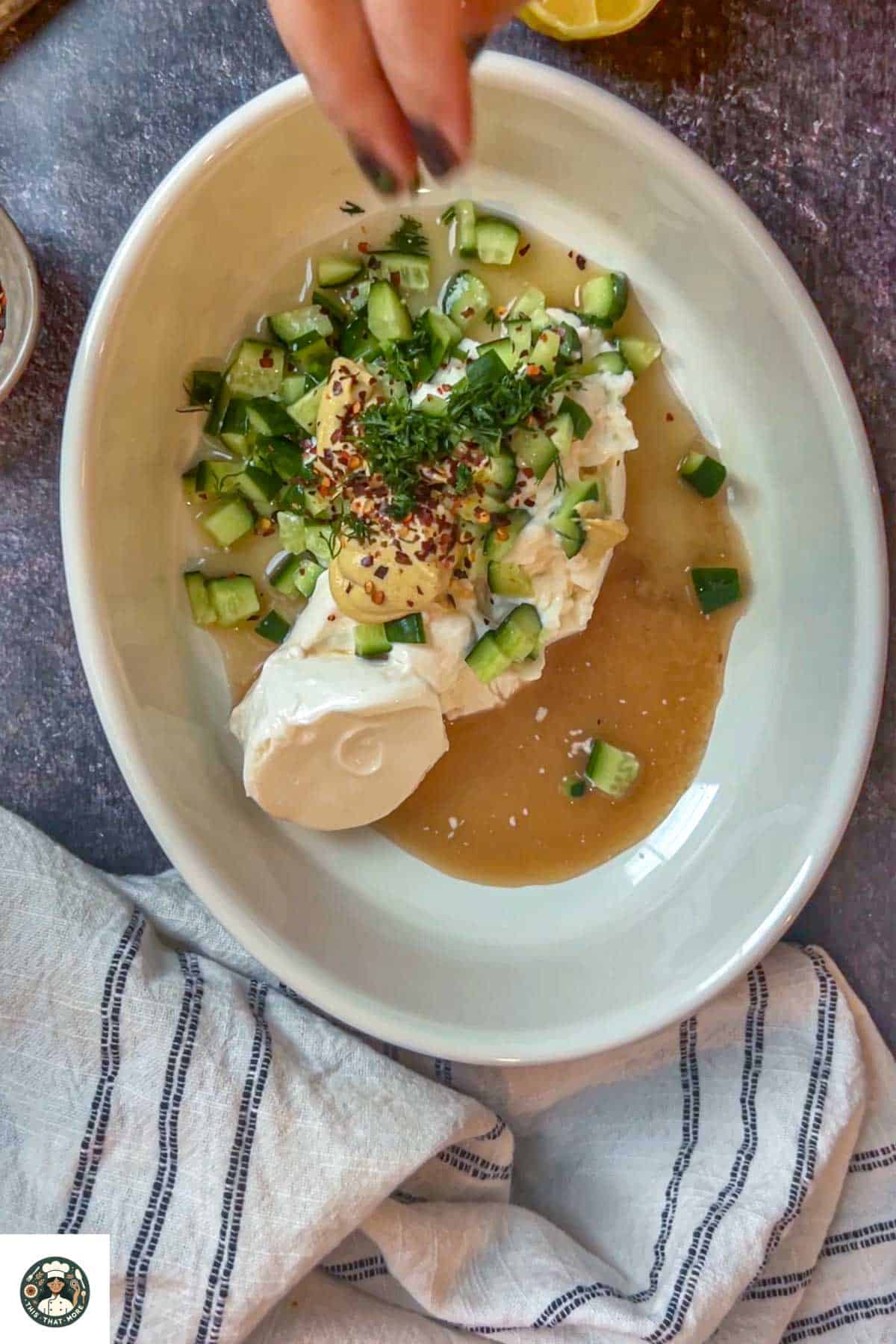 In a bowl add mayonnaise, greek yogurt, parsley, dilll leaves, dijon mustard, lemon juice, red wine vinegar, and red chili flakes.