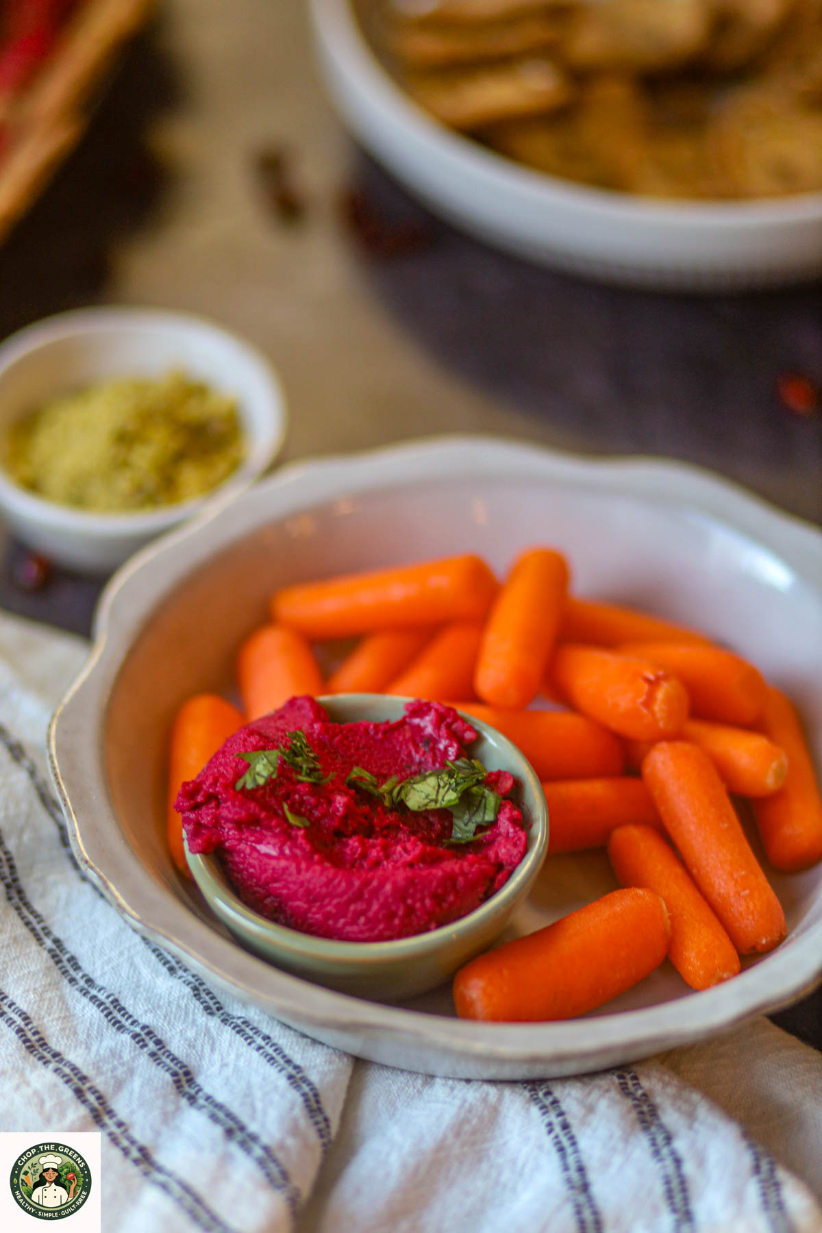 Beetroot hummus served with fresh carrot sticks.