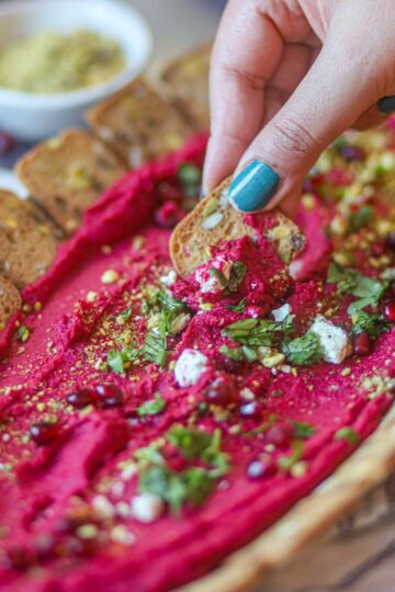 Beetroot hummus recipe served as a colorful appetizer platter.