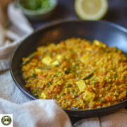 Cooking masala oats with vegetables in a pan.