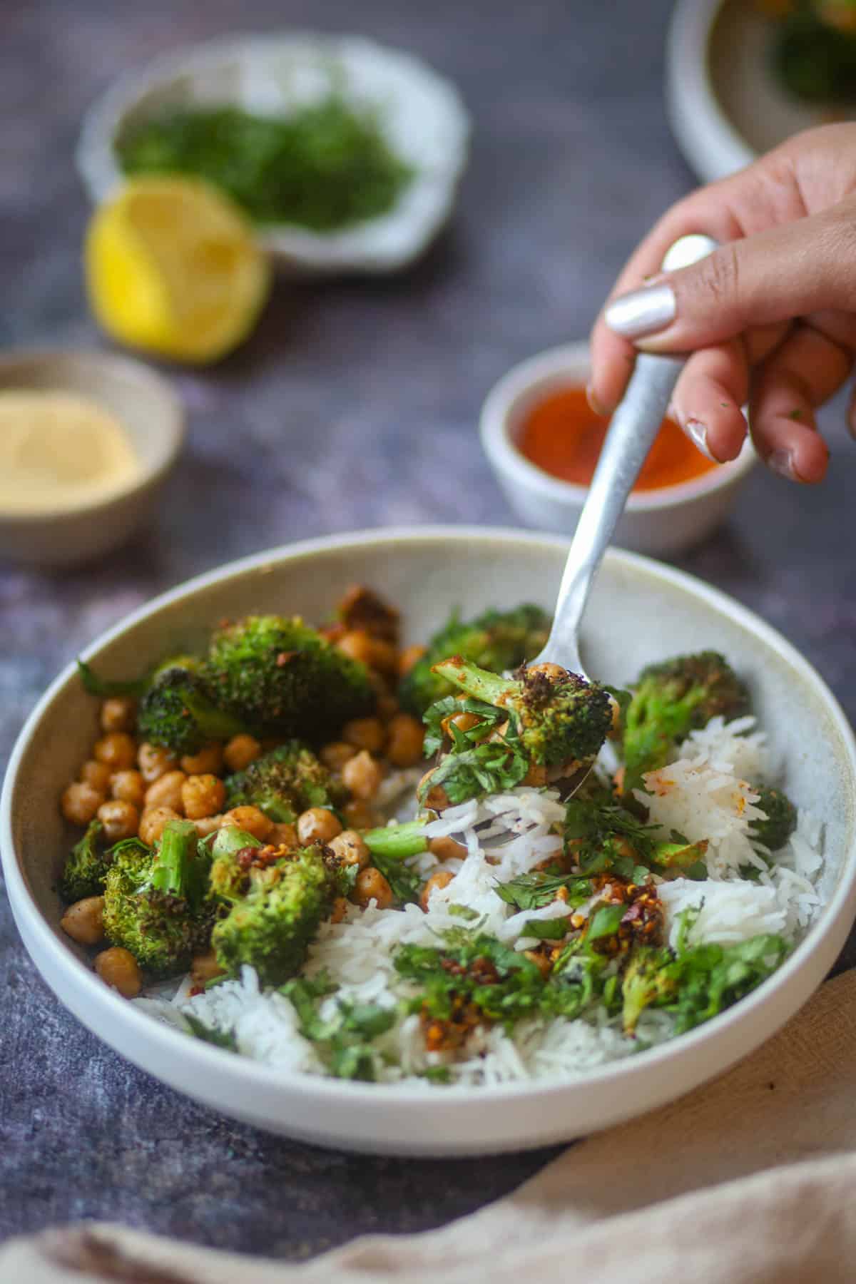 Close up of crispy air fryer broccoli and chickpeas on a fork.