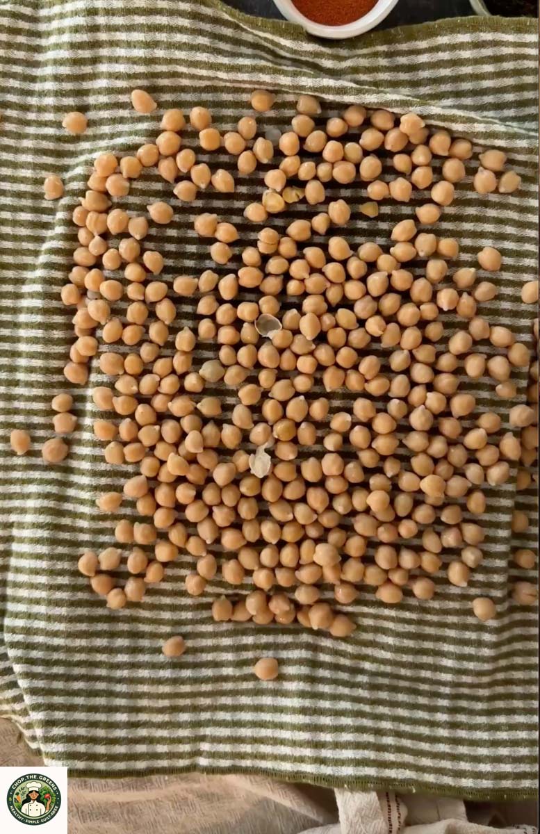 Chickpeas drying on a kitchen towel before air frying.