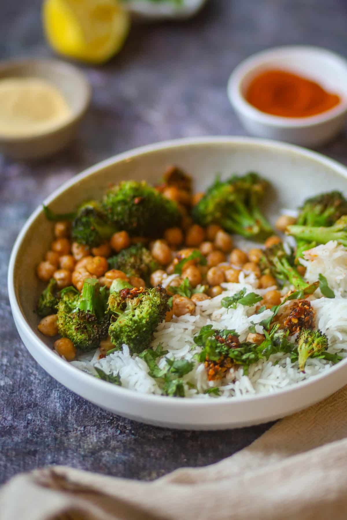 Air fryer broccoli and chickpeas served over rice in a healthy bowl.