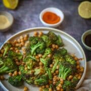 Air fryer roasted broccoli and chickpeas seasoned with spices on a plate.