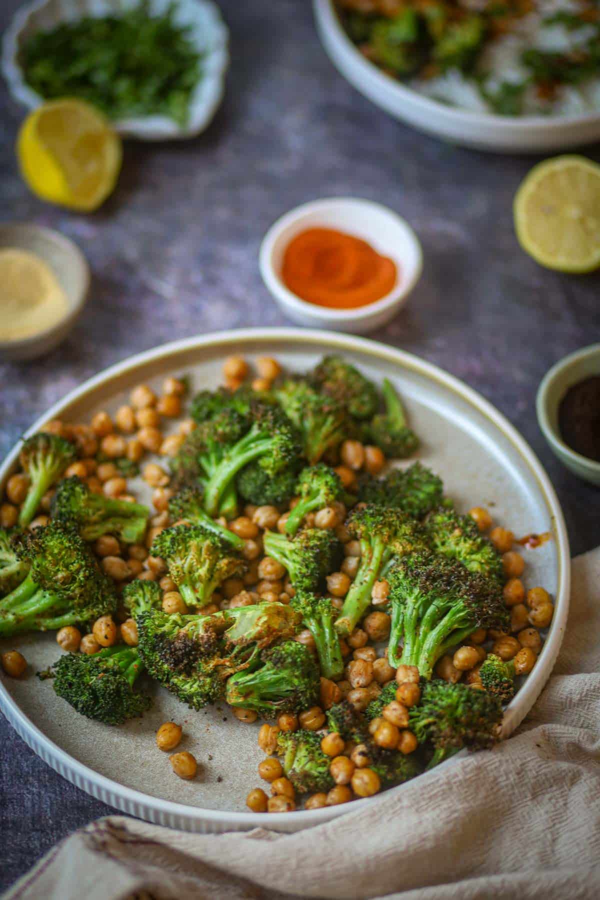 Air fryer roasted broccoli and chickpeas seasoned with spices on a plate
