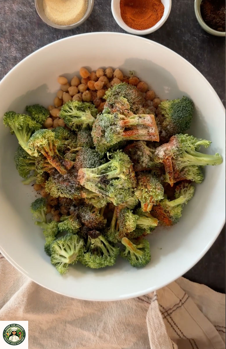 Broccoli and chickpeas tossed with spices before air frying.