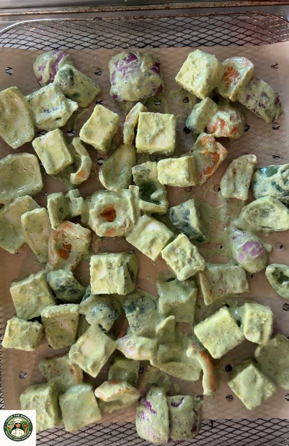 Marinated hariyali paneer tikka arranged in air fryer basket.