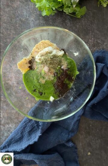 Besan yogurt, spices, and green marinade mixed in a bowl.
