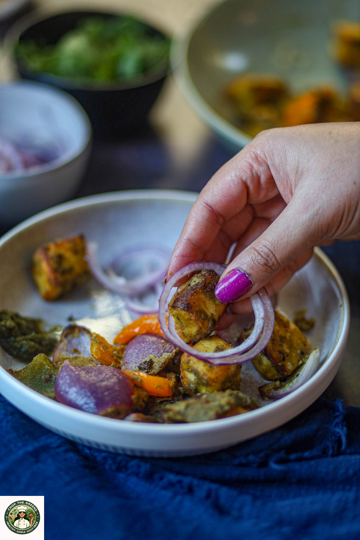 Hariyali paneer tikka served with raw onion rings.