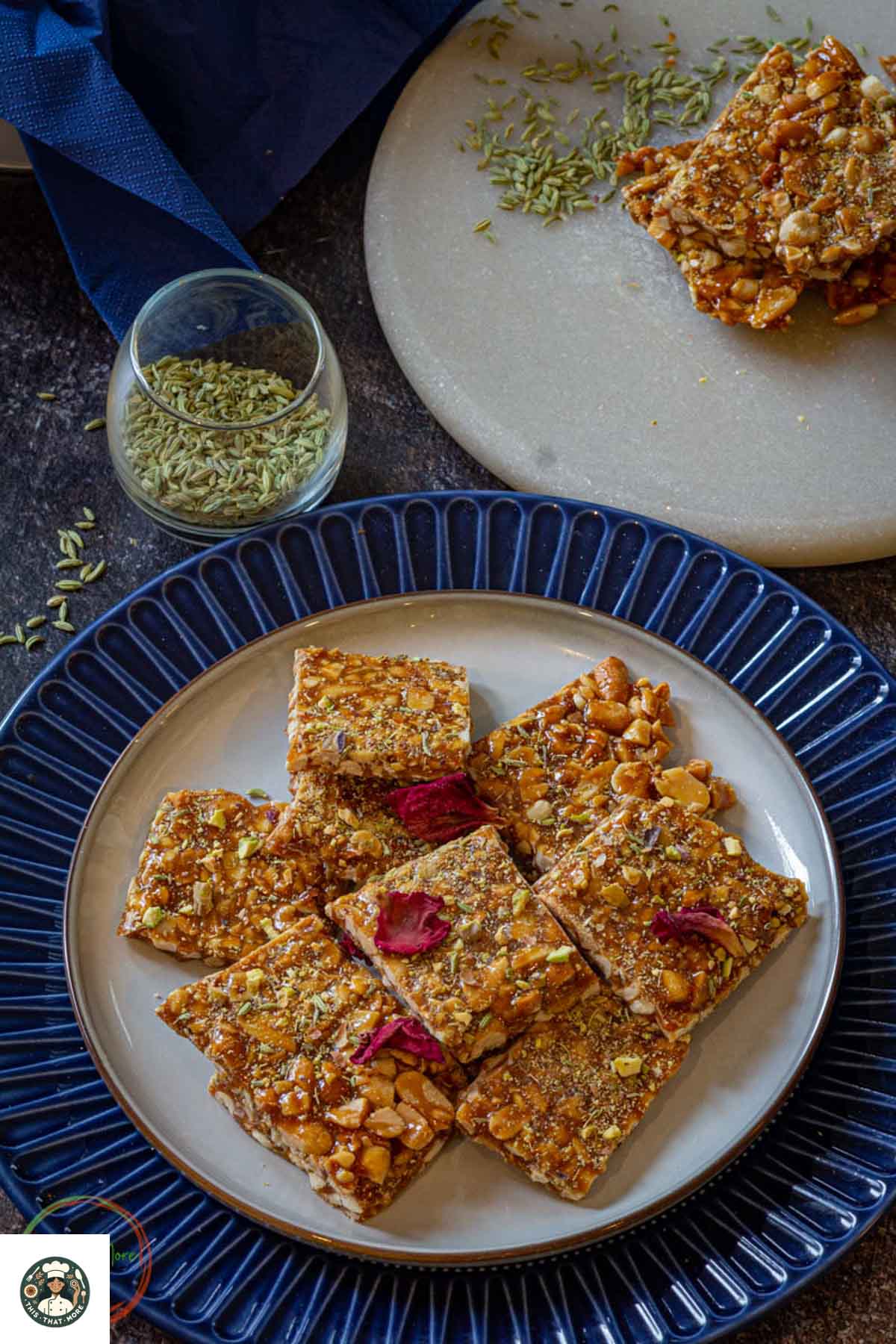 Homemade peanut chikki arranged on a platter, cut into even squares. This traditional Indian sweet is naturally vegan and gluten-free.