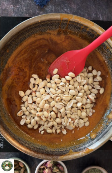 Mixing roasted peanuts into jaggery syrup for peanut gajak.
