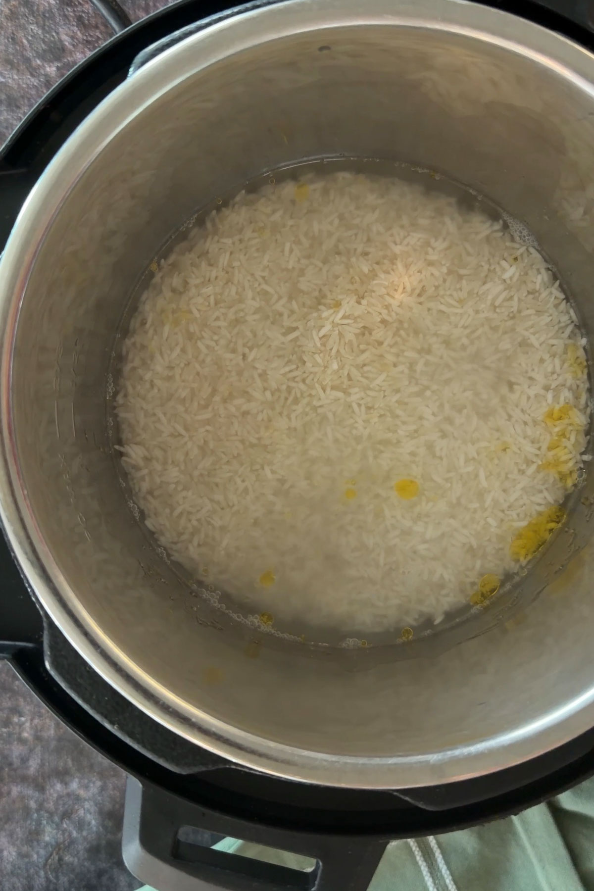 Basmati rice and water inside the Instant Pot before pressure cooking.