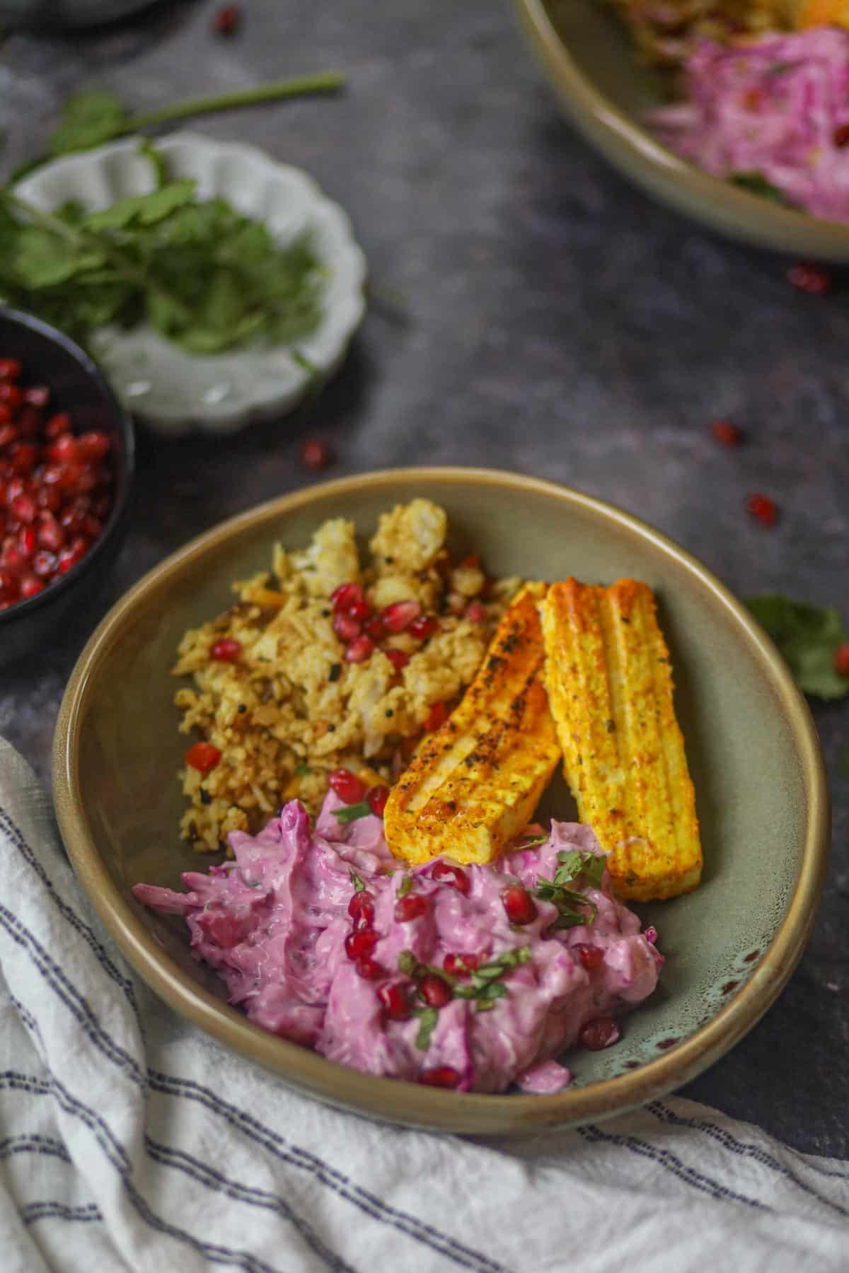 Healthy paneer tikka bowl with beetroot yogurt raita and grilled paneer.