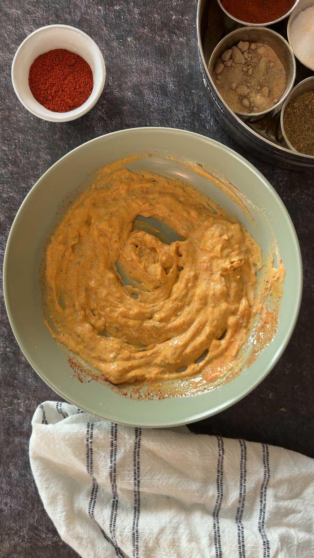 Spiced yogurt marinade mixed for paneer tikka.