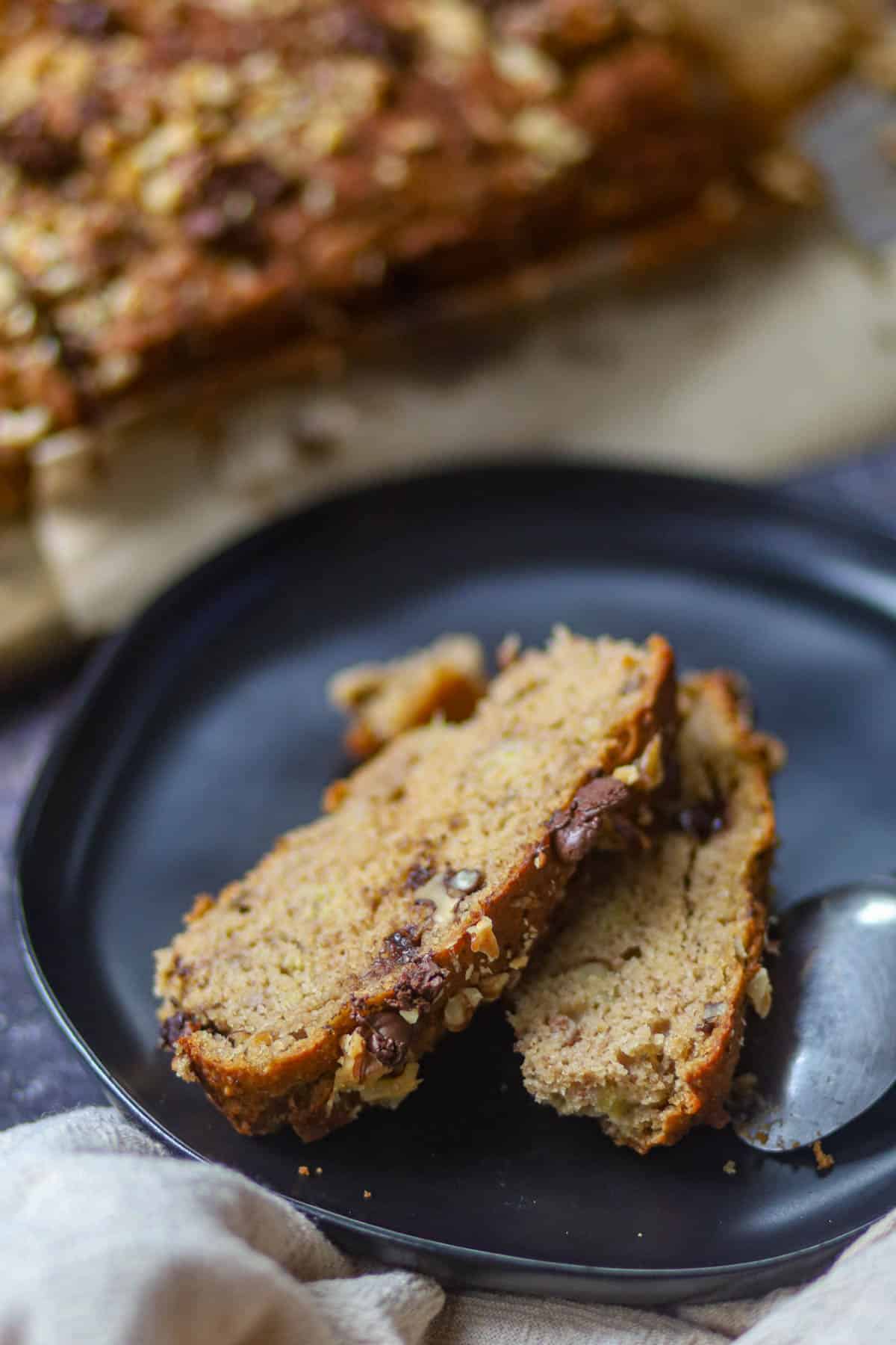 Slice of eggless banana bread served on a plate.