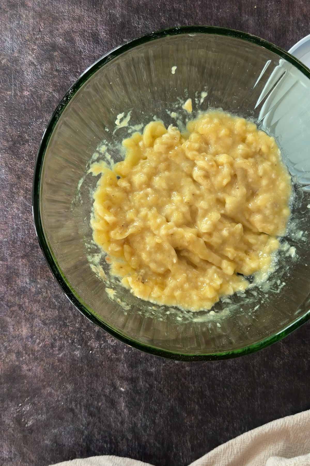 Mashed ripe bananas in a bowl for banana bread recipe.