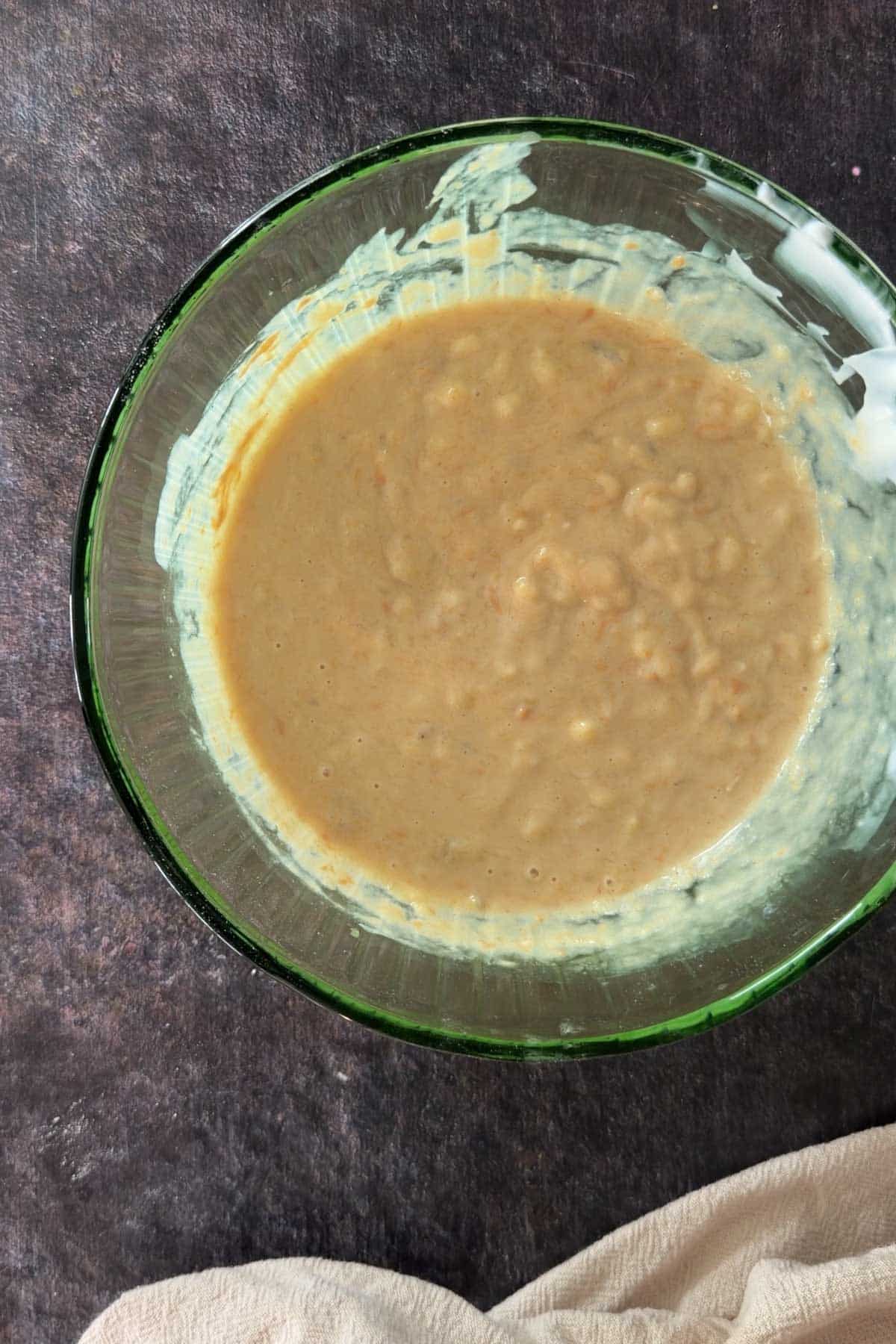 Banana bread batter mixture in a bowl before adding dry ingredients.